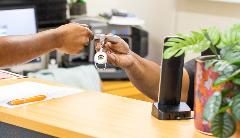 Hostel Manager providing resident with their access key.