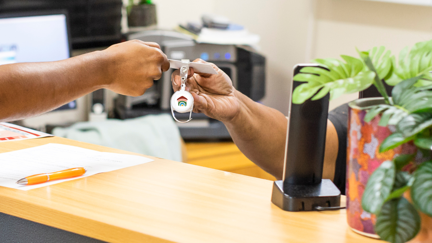 Hostel Manager providing resident with their access key.